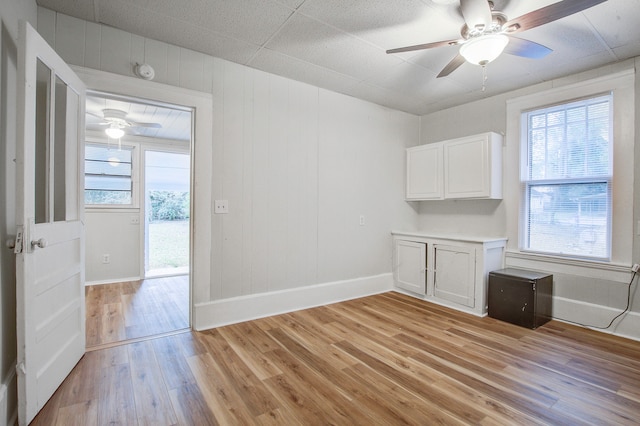 unfurnished room with light hardwood / wood-style flooring, a wealth of natural light, and ceiling fan