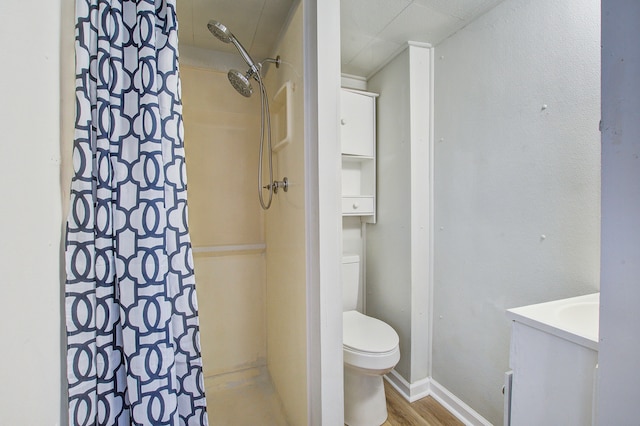 bathroom featuring a shower with shower curtain, vanity, hardwood / wood-style flooring, and toilet