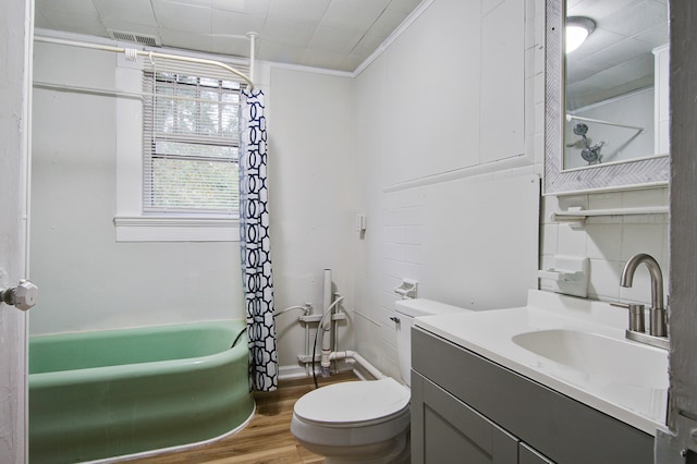 bathroom featuring crown molding, hardwood / wood-style floors, vanity, and toilet