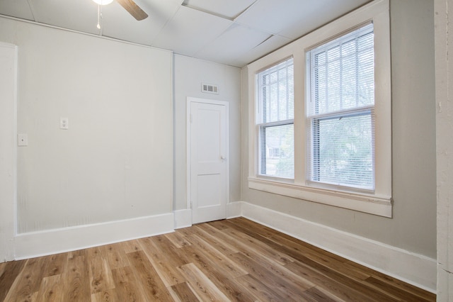 empty room featuring hardwood / wood-style flooring and ceiling fan