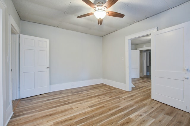 empty room with light hardwood / wood-style floors and ceiling fan