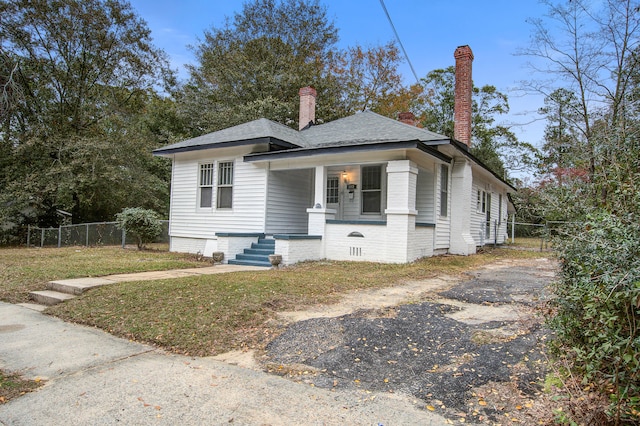 view of front of property with covered porch and a front yard