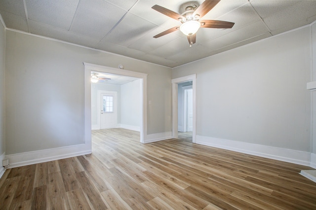 unfurnished room with ceiling fan, light hardwood / wood-style flooring, and ornamental molding