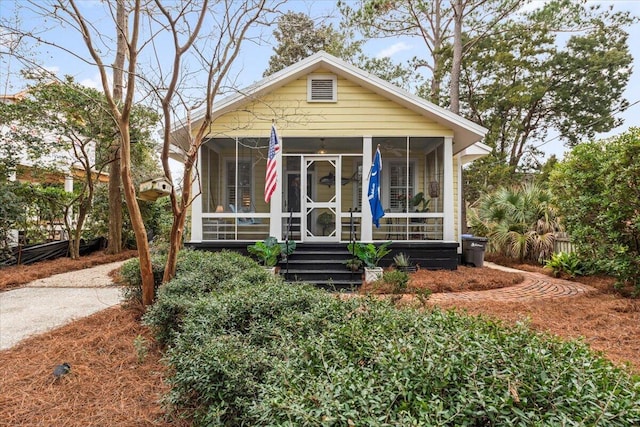 bungalow-style house featuring a sunroom