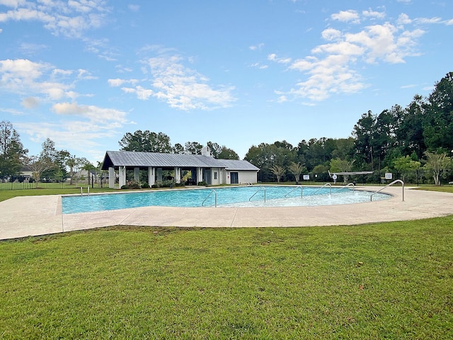 community pool with a lawn and fence