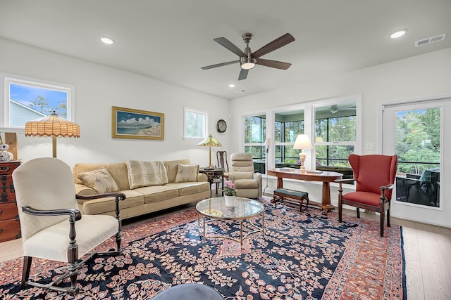 living area featuring wood-type flooring, visible vents, and recessed lighting