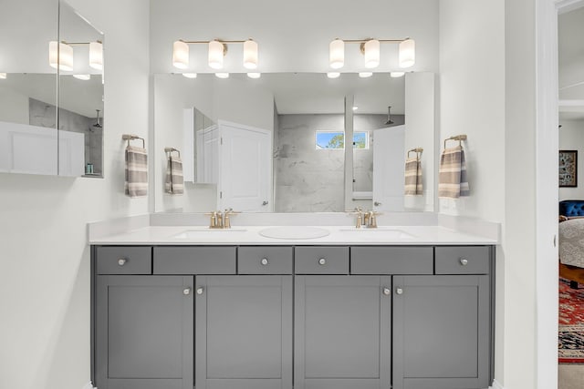 full bathroom featuring double vanity, a walk in shower, a sink, and ensuite bathroom