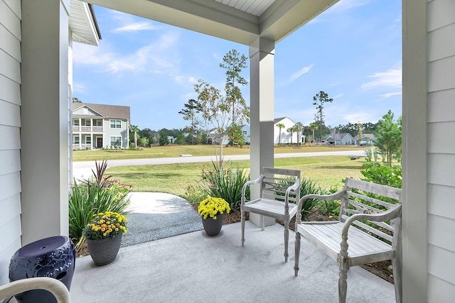 view of patio / terrace with a residential view and a porch