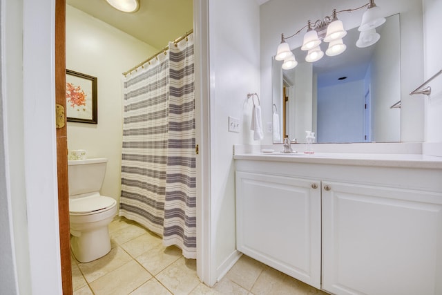 bathroom with vanity, toilet, and tile patterned floors