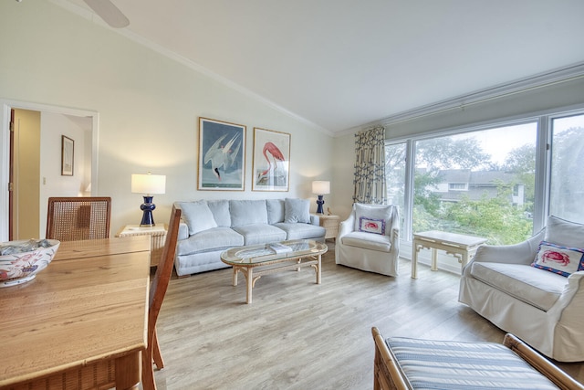 living room with vaulted ceiling, crown molding, and light hardwood / wood-style floors