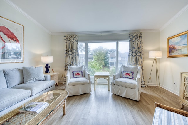 living room with light hardwood / wood-style flooring and ornamental molding