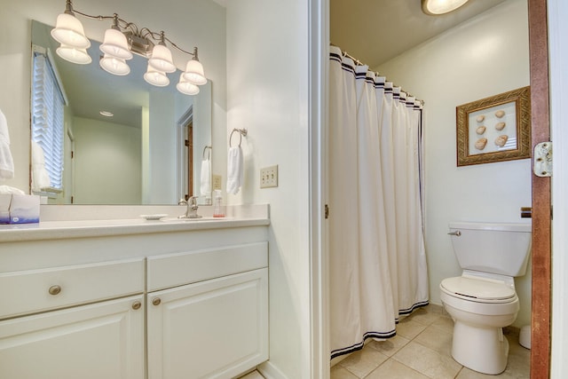 bathroom with vanity, toilet, and tile patterned flooring