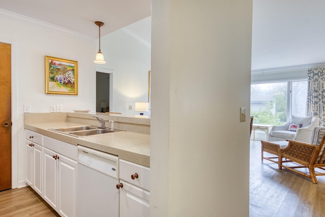 kitchen featuring white dishwasher, sink, light hardwood / wood-style floors, white cabinetry, and ornamental molding