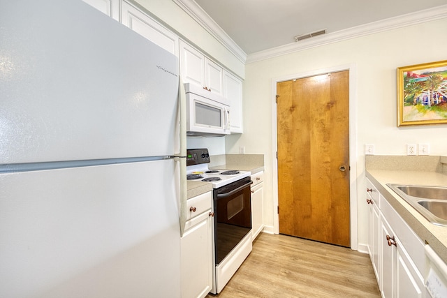 kitchen with sink, light hardwood / wood-style flooring, white appliances, and white cabinets