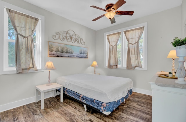 bedroom featuring ceiling fan and dark hardwood / wood-style floors