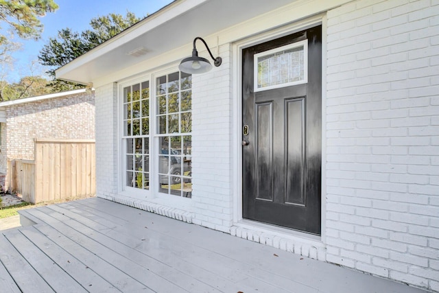 entrance to property with a wooden deck