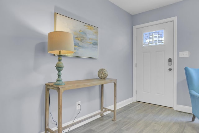 foyer entrance with light hardwood / wood-style flooring