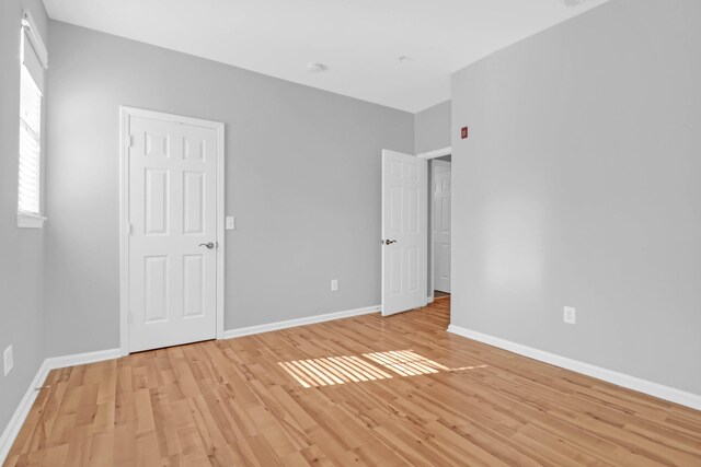 unfurnished bedroom with light wood-type flooring