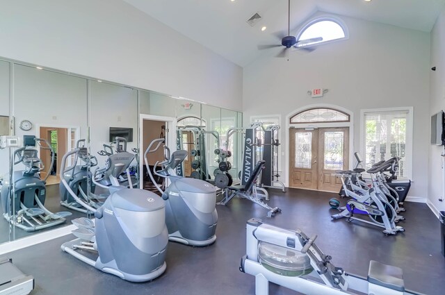 exercise room featuring french doors, ceiling fan, and high vaulted ceiling