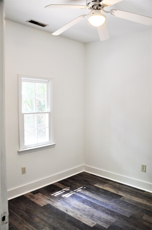 unfurnished room featuring ceiling fan and dark wood-type flooring