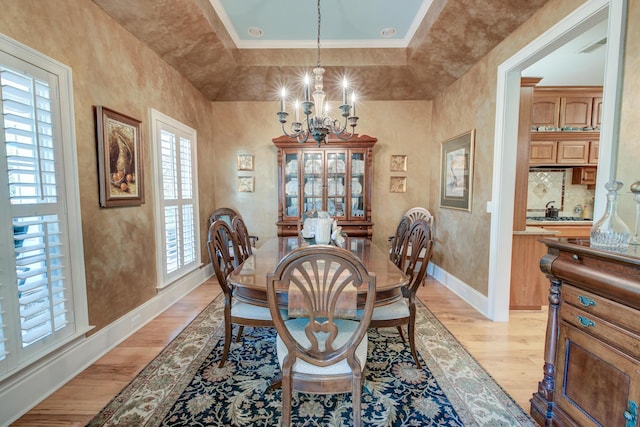 101 Firestone Ct, Summerville, SC 29483 - dining room with light wood-style floors, a chandelier, baseboards, and crown molding