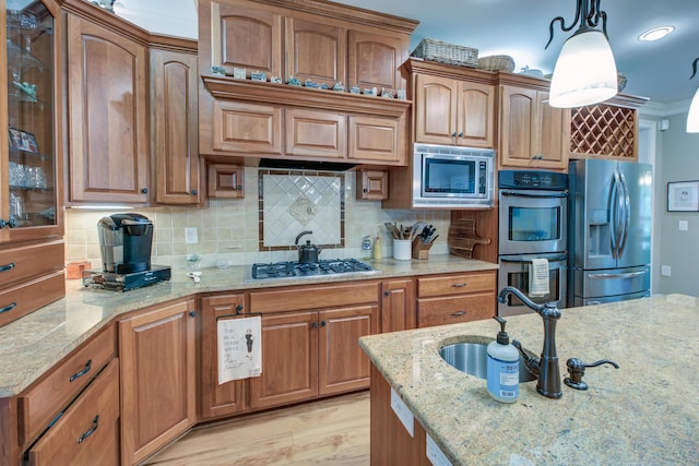 101 Firestone Ct, Summerville, SC 29483 - kitchen featuring stainless steel appliances, glass insert cabinets, backsplash, decorative light fixtures, and light stone counters