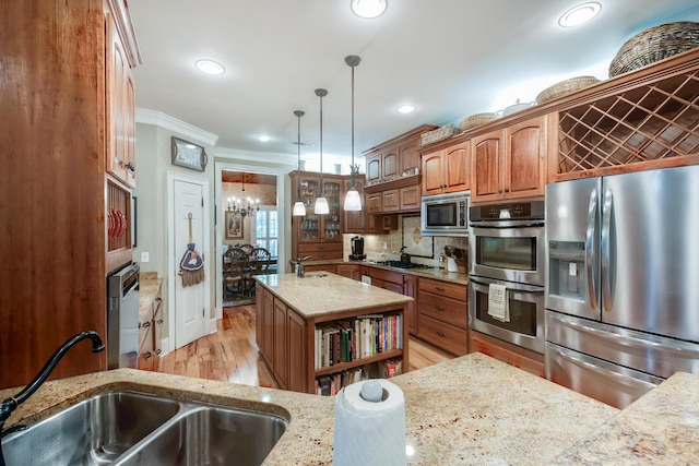 101 Firestone Ct, Summerville, SC 29483 - kitchen with stainless steel appliances, ornamental molding, light stone countertops, a chandelier, and light wood-type flooring