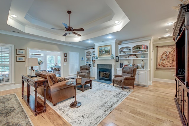 101 Firestone Ct, Summerville, SC 29483 - living area with crown molding, a raised ceiling, a tiled fireplace, a ceiling fan, and baseboards