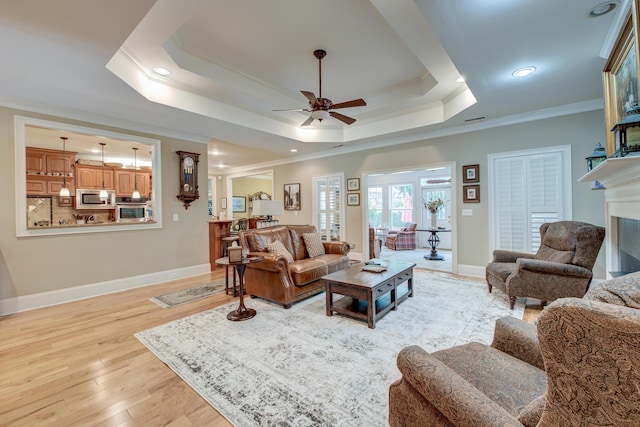 101 Firestone Ct, Summerville, SC 29483 - living area featuring ceiling fan, ornamental molding, a tray ceiling, light wood-type flooring, and baseboards