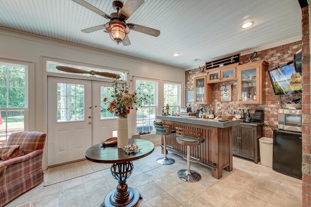 101 Firestone Ct, Summerville, SC 29483 - kitchen with a kitchen bar, healthy amount of natural light, a ceiling fan, glass insert cabinets, and ornamental molding