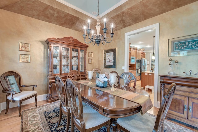 101 Firestone Ct, Summerville, SC 29483 - dining room with baseboards, a chandelier, light wood-type flooring, and crown molding
