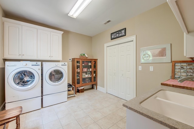 101 Firestone Ct, Summerville, SC 29483 - laundry area featuring separate washer and dryer, cabinet space, and light tile patterned floors