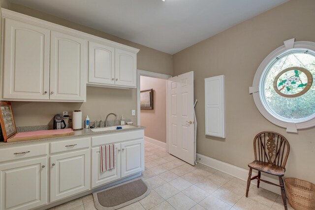 101 Firestone Ct, Summerville, SC 29483 - kitchen featuring a sink, light tile patterned floors, baseboards, light countertops, and white cabinets