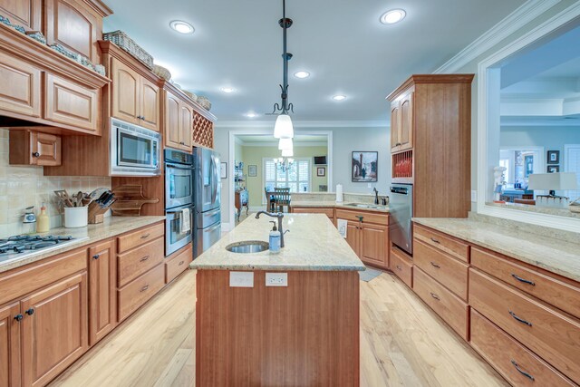 101 Firestone Ct, Summerville, SC 29483 - kitchen featuring a sink, stainless steel appliances, ornamental molding, an island with sink, and light stone counters