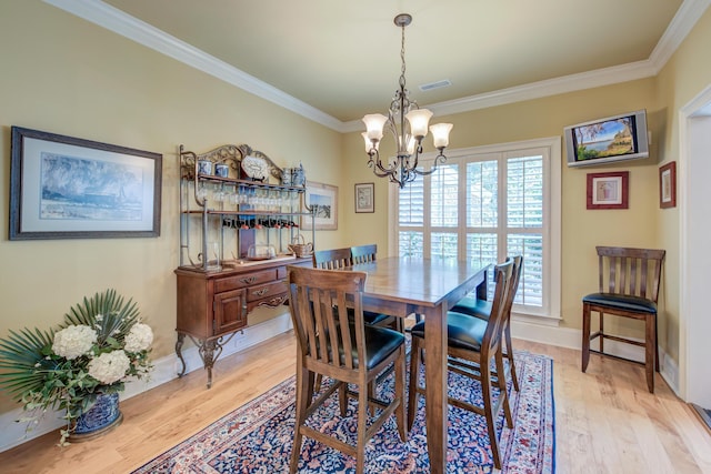 101 Firestone Ct, Summerville, SC 29483 - dining room with a chandelier, crown molding, light wood finished floors, and baseboards