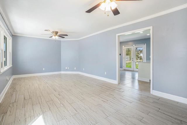 spare room with a ceiling fan, baseboards, ornamental molding, french doors, and light wood-type flooring