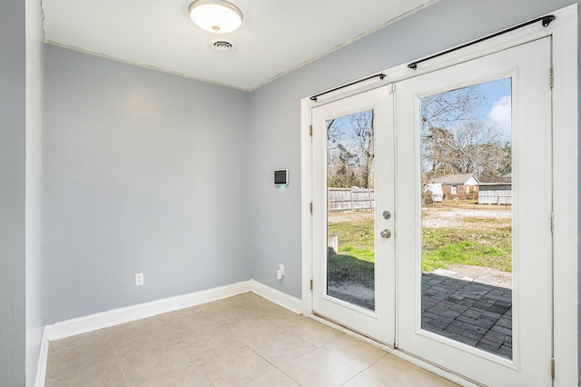 doorway featuring french doors, visible vents, baseboards, and light tile patterned flooring