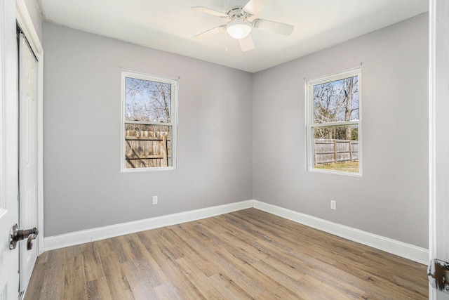 unfurnished bedroom with a ceiling fan, a closet, baseboards, and wood finished floors