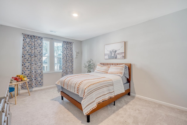 carpeted bedroom with visible vents and baseboards