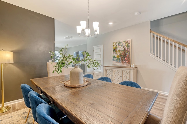 dining area featuring a notable chandelier, recessed lighting, wood finished floors, and baseboards