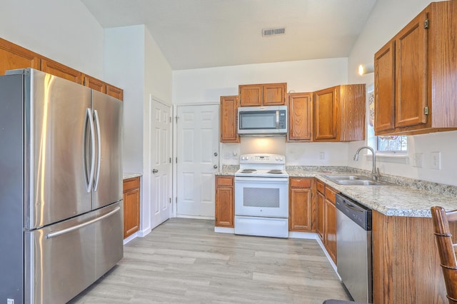 kitchen featuring sink, light hardwood / wood-style floors, and appliances with stainless steel finishes