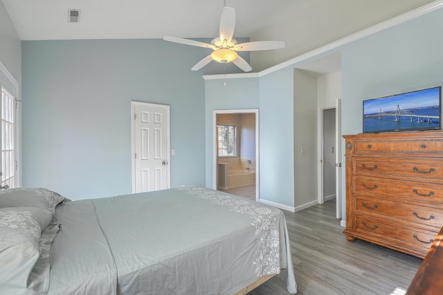 bedroom featuring connected bathroom, hardwood / wood-style floors, crown molding, and ceiling fan