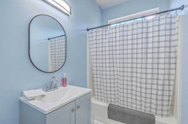 bathroom featuring vanity and shower / bath combination with curtain