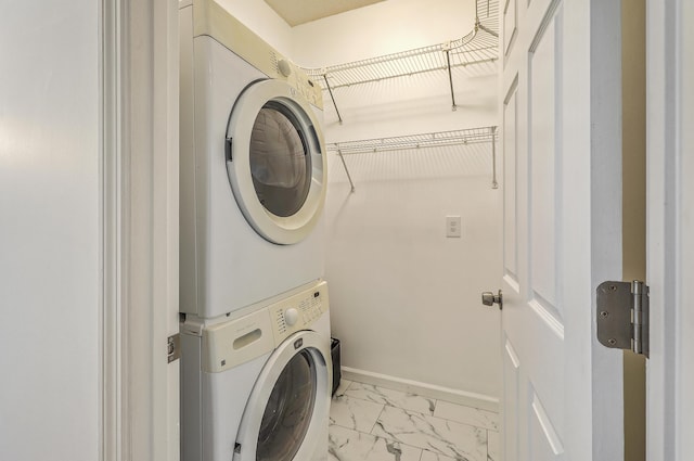 clothes washing area featuring stacked washing maching and dryer