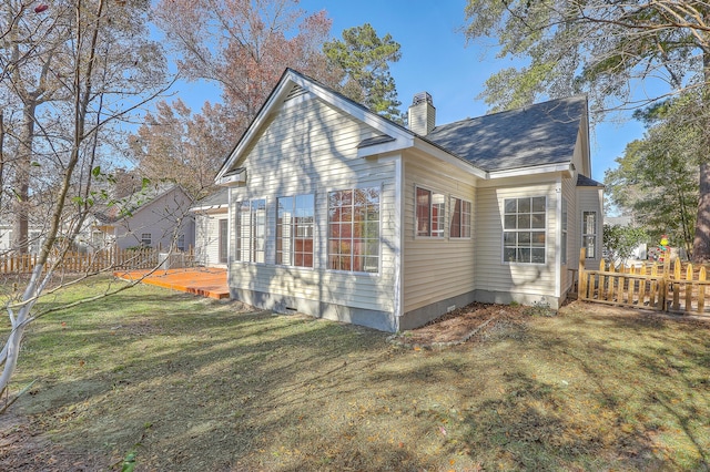 view of side of home with a yard