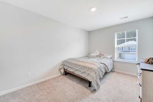 bedroom featuring light carpet