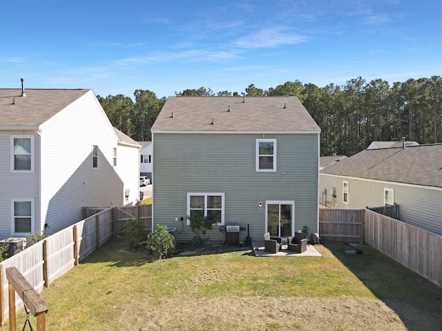 rear view of property with a lawn and a patio