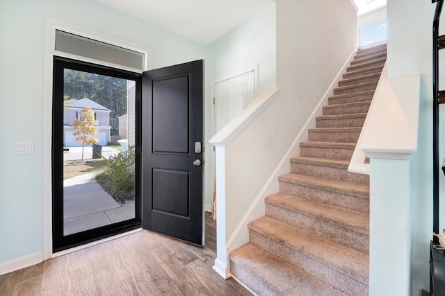 foyer entrance with light hardwood / wood-style flooring and a healthy amount of sunlight