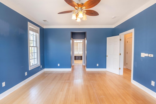 unfurnished bedroom with baseboards, ornamental molding, and light wood finished floors