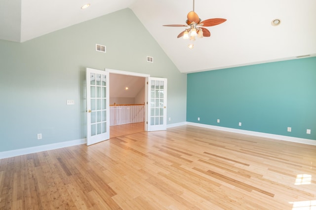 spare room with a ceiling fan, french doors, visible vents, light wood-type flooring, and high vaulted ceiling